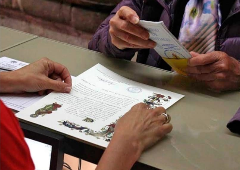 Pilgrim’s credential stamped along the Camino de Santiago beside the Compostela certificate, one of the Symbols of El Camino