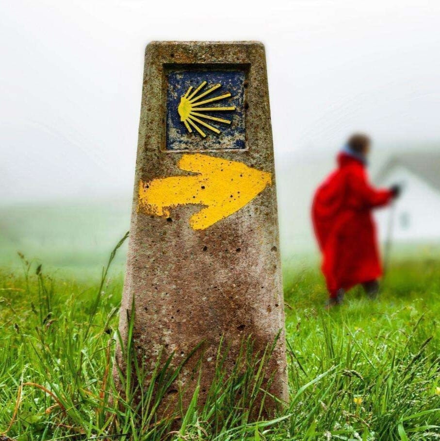 Yellow Arrow painted on a marker stone, indicating The Way - Symbols of El Camino