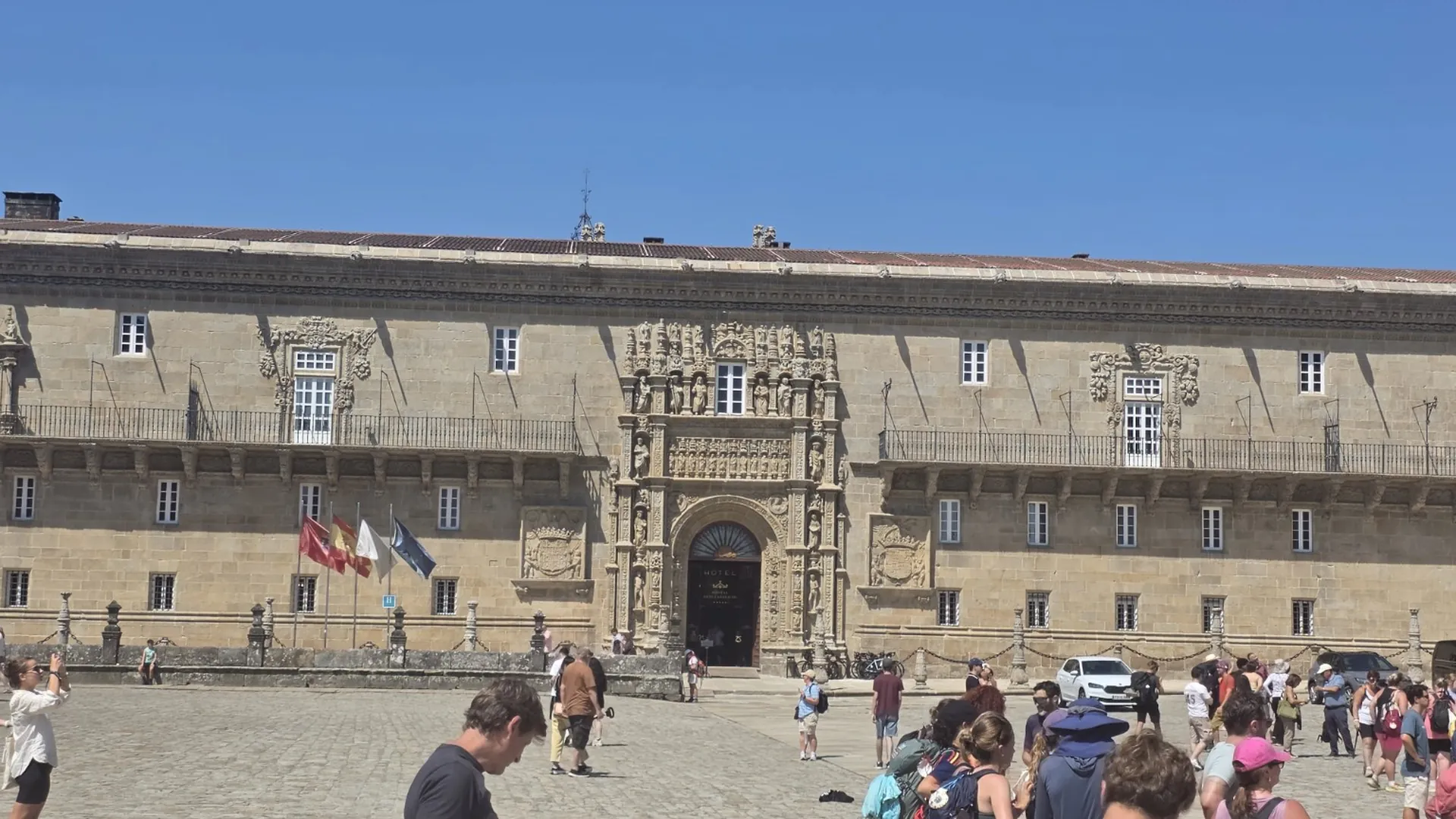 Pilgrims gathered in front of the Hostal de los Reyes Católicos in Santiago de Compostela
